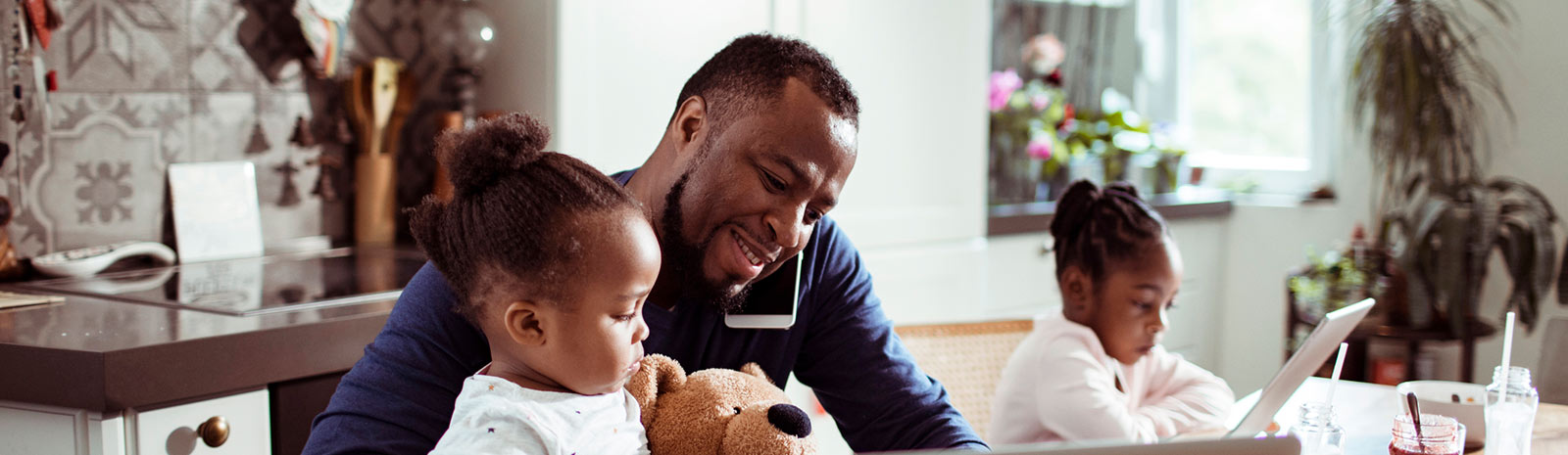 a father engaging with his twin daughters