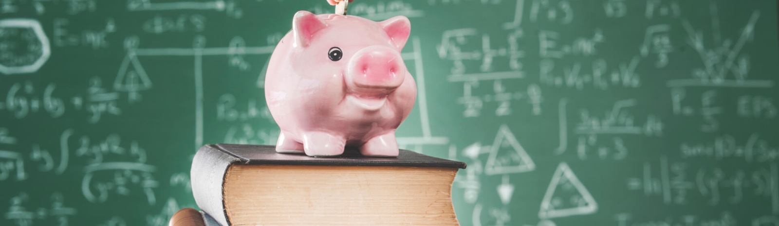 a piggy bank on a stack of books