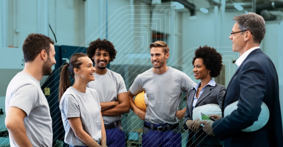 a group of factory workers engaged in a conversation