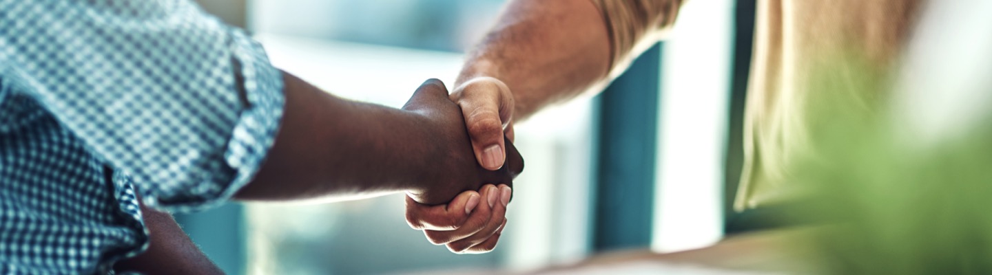 two men engaged in a handshake