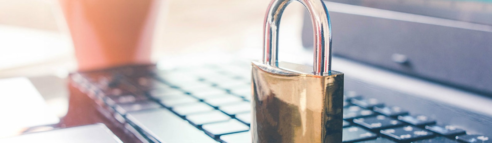 a brass lock on a laptop computer keyboard