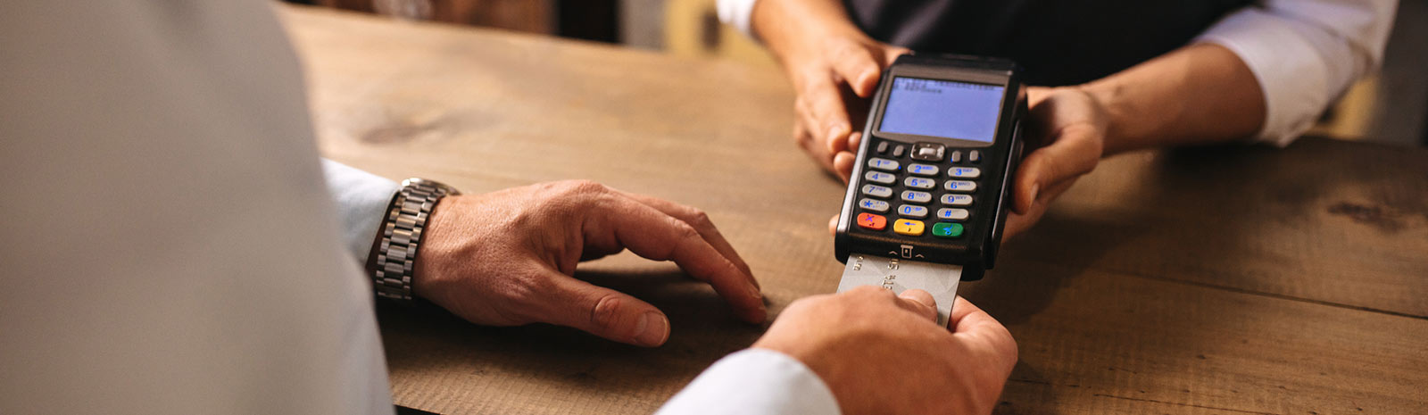 a person using a credit reader to make a purchase