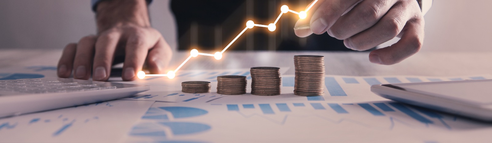 a person stacking coins on a desk